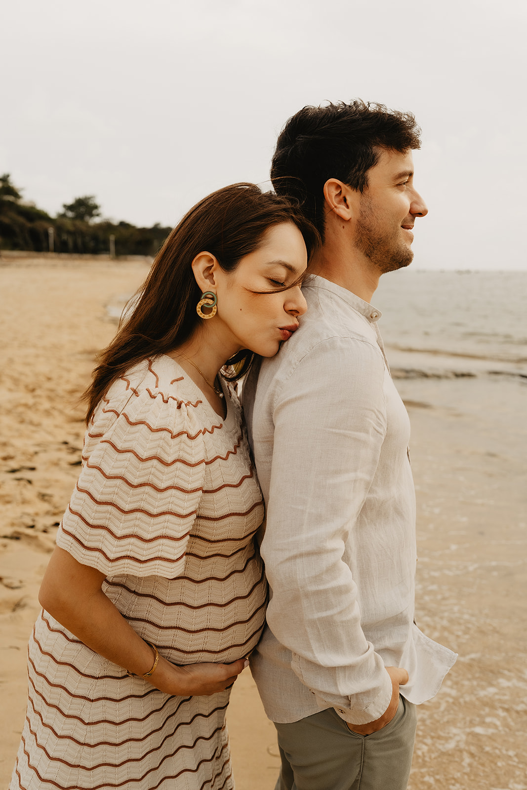 Silhouette de femme enceinte en contre-jour au coucher du soleil